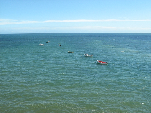 Small boats in a beautiful blue-green sea off Robin Hoods Bay
